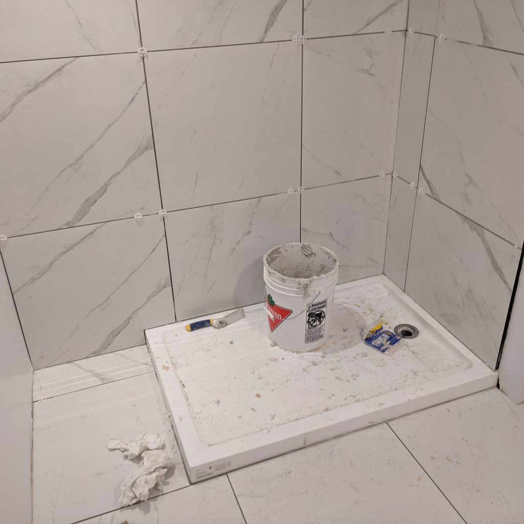 Image of shower tray damage for maximizing jobsite profit blog by Axiom, supplier to Canada/ North America construction professionals